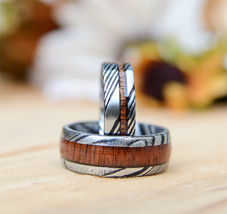 Match His and Hers Damascus Steel Pattern Wedding Band Sets with Koa Wood Inlay
